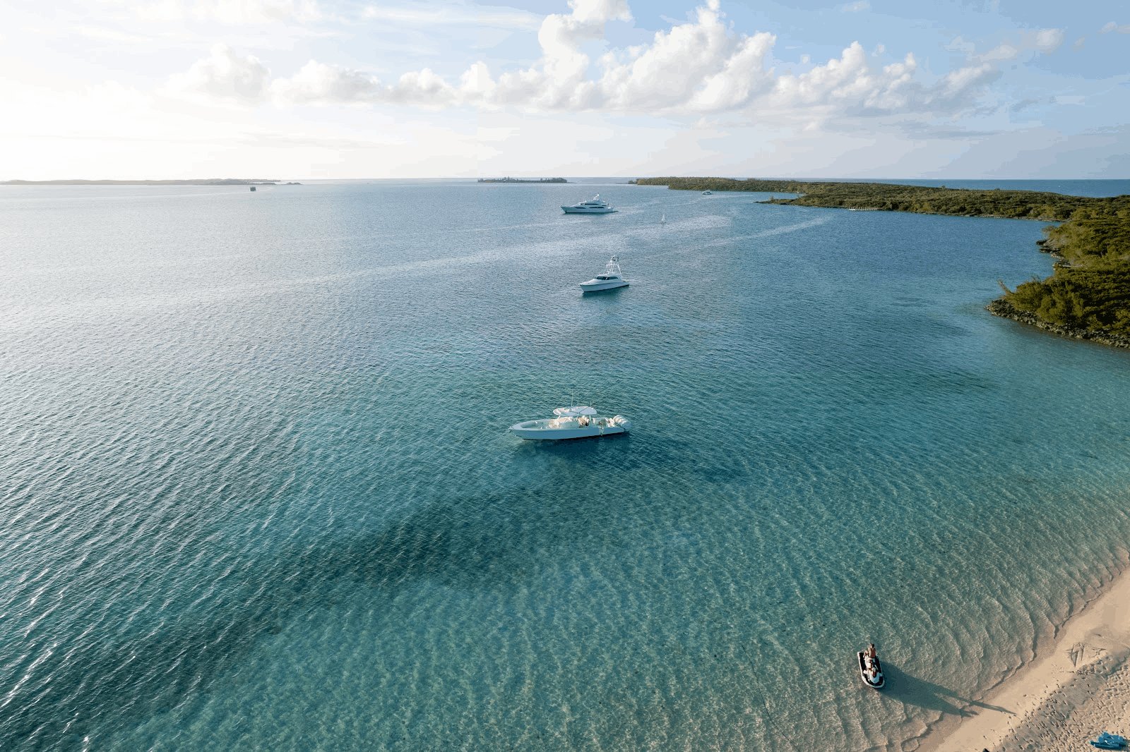 M/Y Avalon and her tenders anchored off a beach