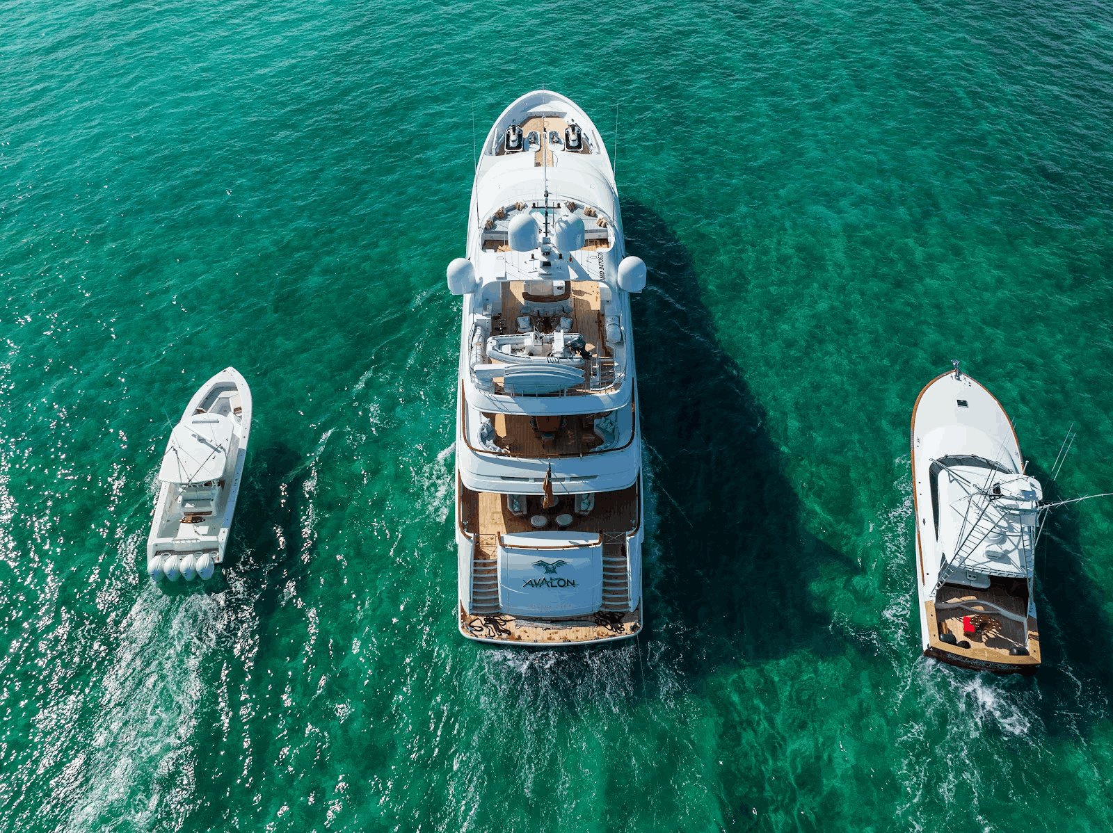 Avalon at anchor flanked by tenders